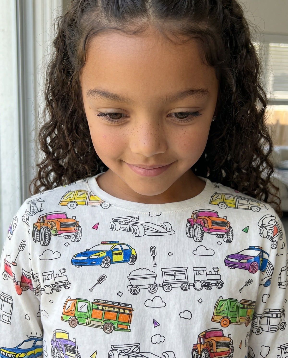 Close-up of Vehicle Colouring Pyjama top showing colourful transport designs