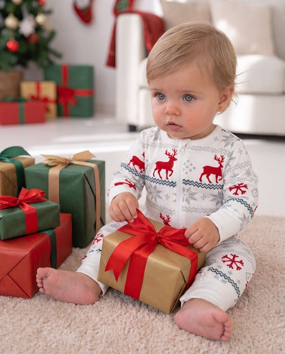 Cute Baby Girl opening a present at Christmas Time in LUXE Nordic romper