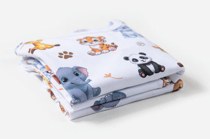 Folded white animal print children's pyjamas showing premium soft cotton fabric