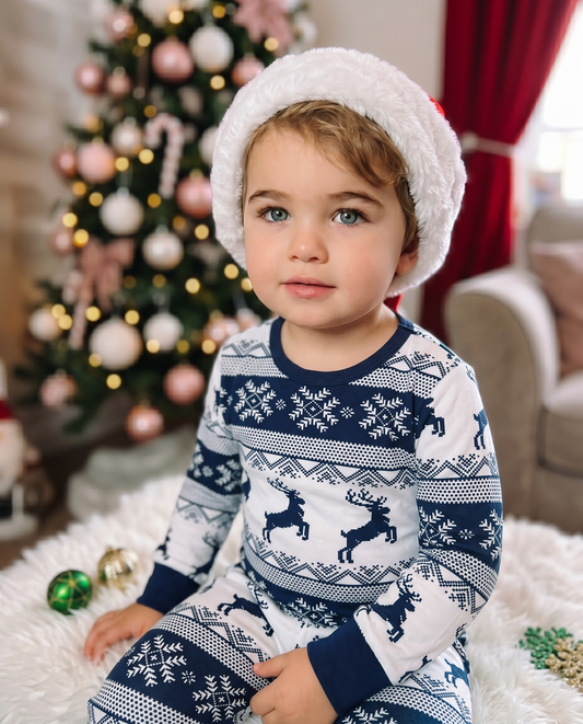 Child relaxing in Cubwear navy Fair Isle Christmas pyjamas during magical festive movie night.