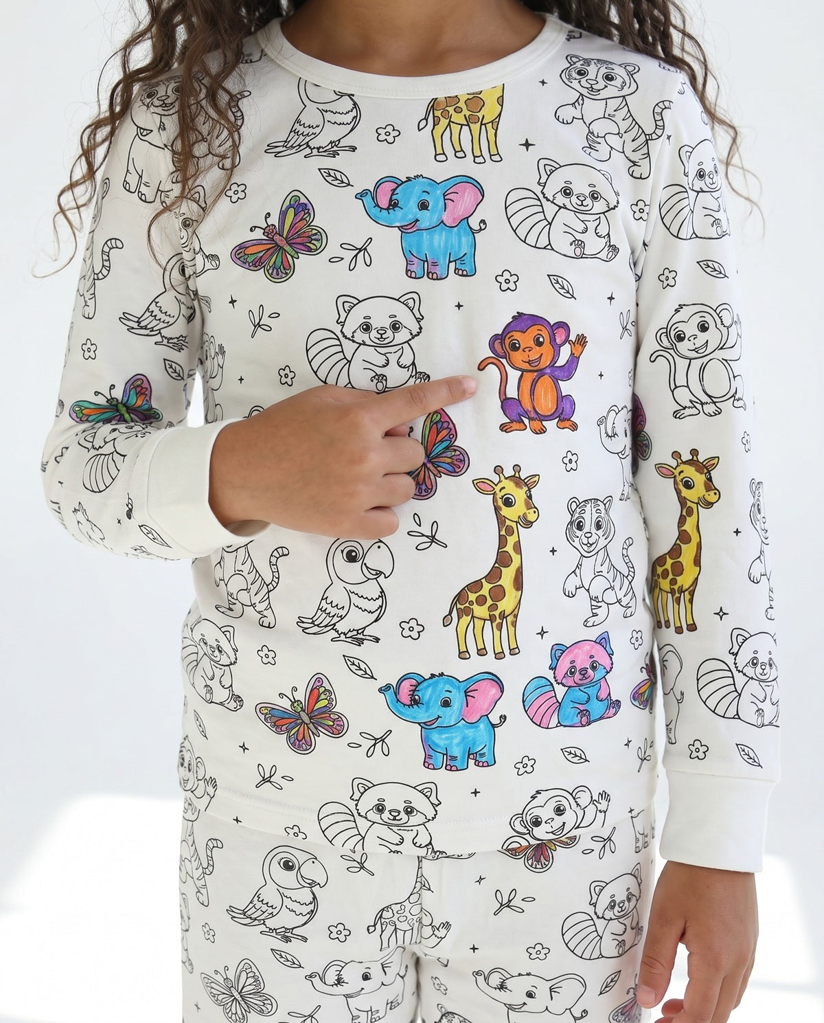 Girl wearing personalised Animal Colouring Pyjamas decorated with colourful animals
