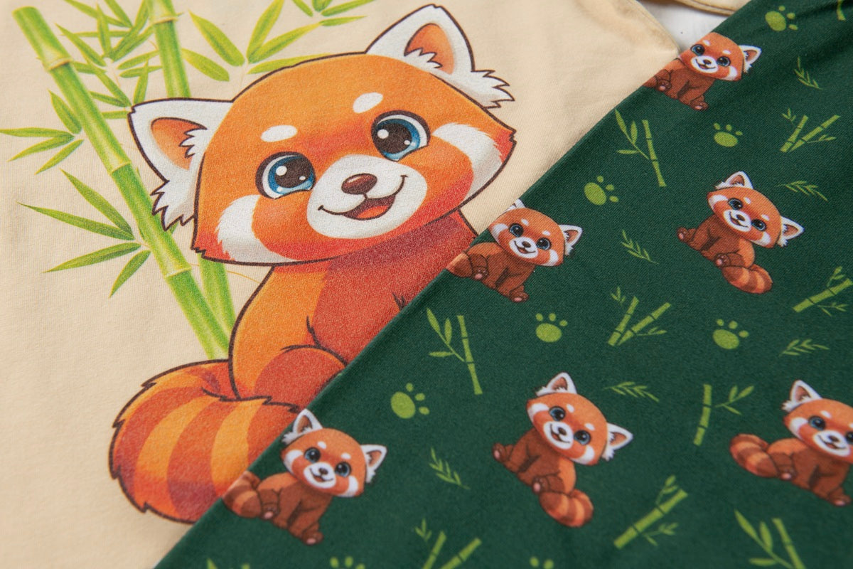 Two fabric pieces featuring cute red panda illustrations, one in beige with green bamboo and one in dark green with small red panda prints.